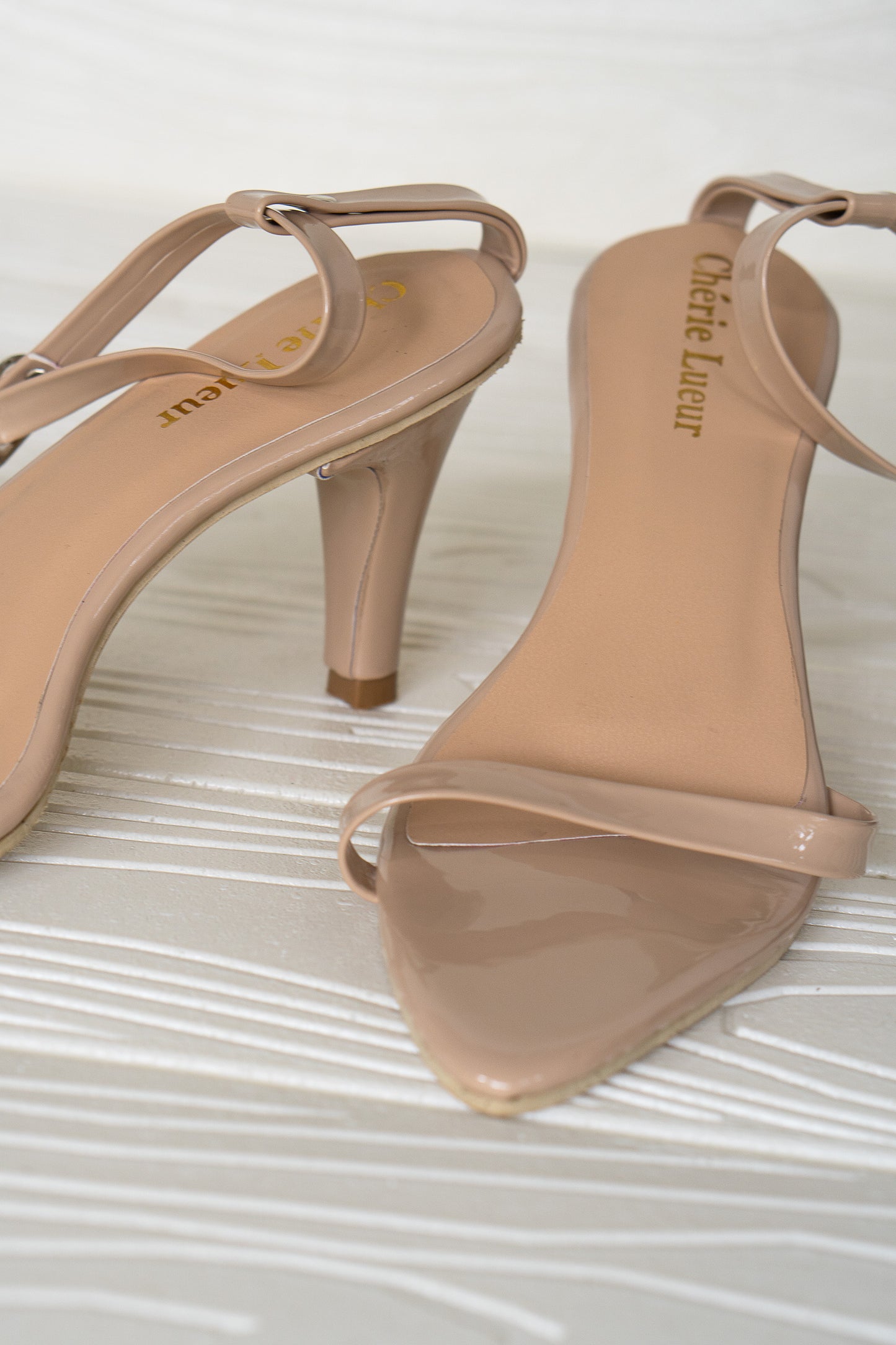 Elegant nude heel boasting a 3-inch height