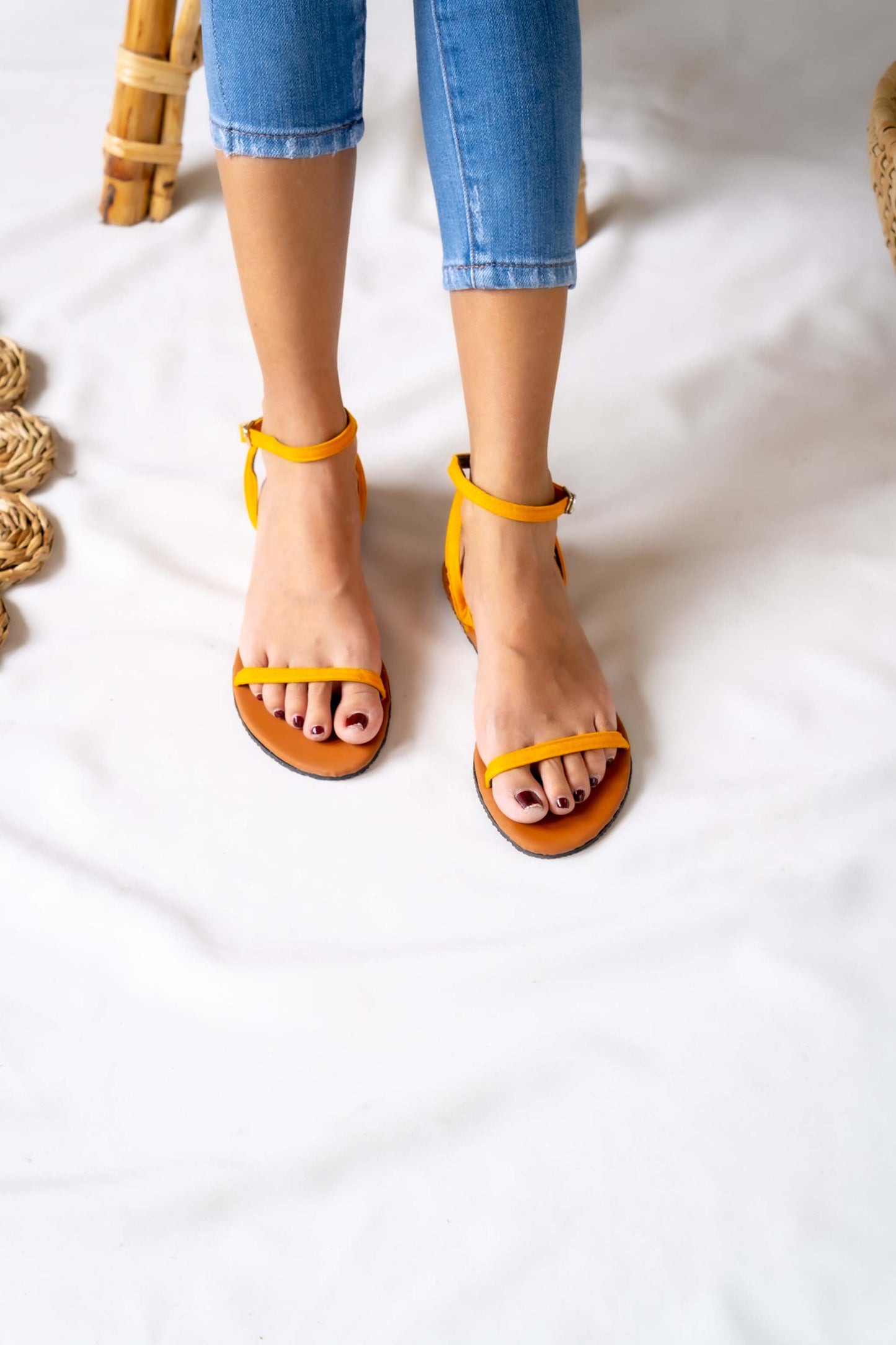 Sunny and stylish, this ladies' yellow flat sandal brings a pop of color to any outfit