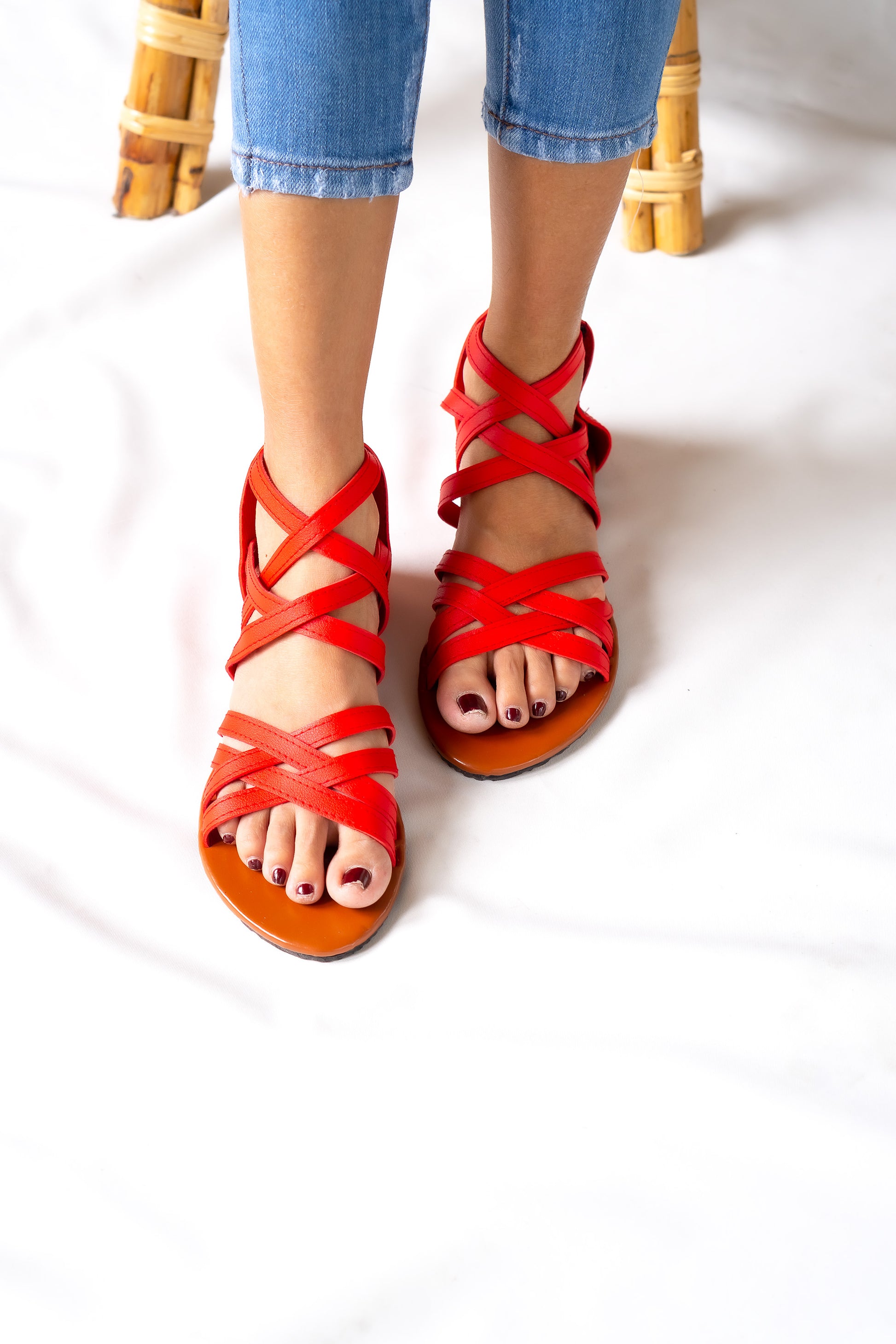 Bold and stylish red gladiator flat sandal for ladies, featuring a convenient zip closure