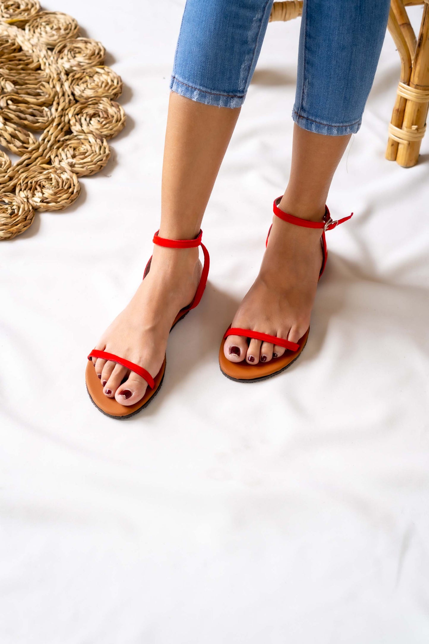 Sunny and stylish, this ladies' red flat sandal brings a pop of color to any outfit