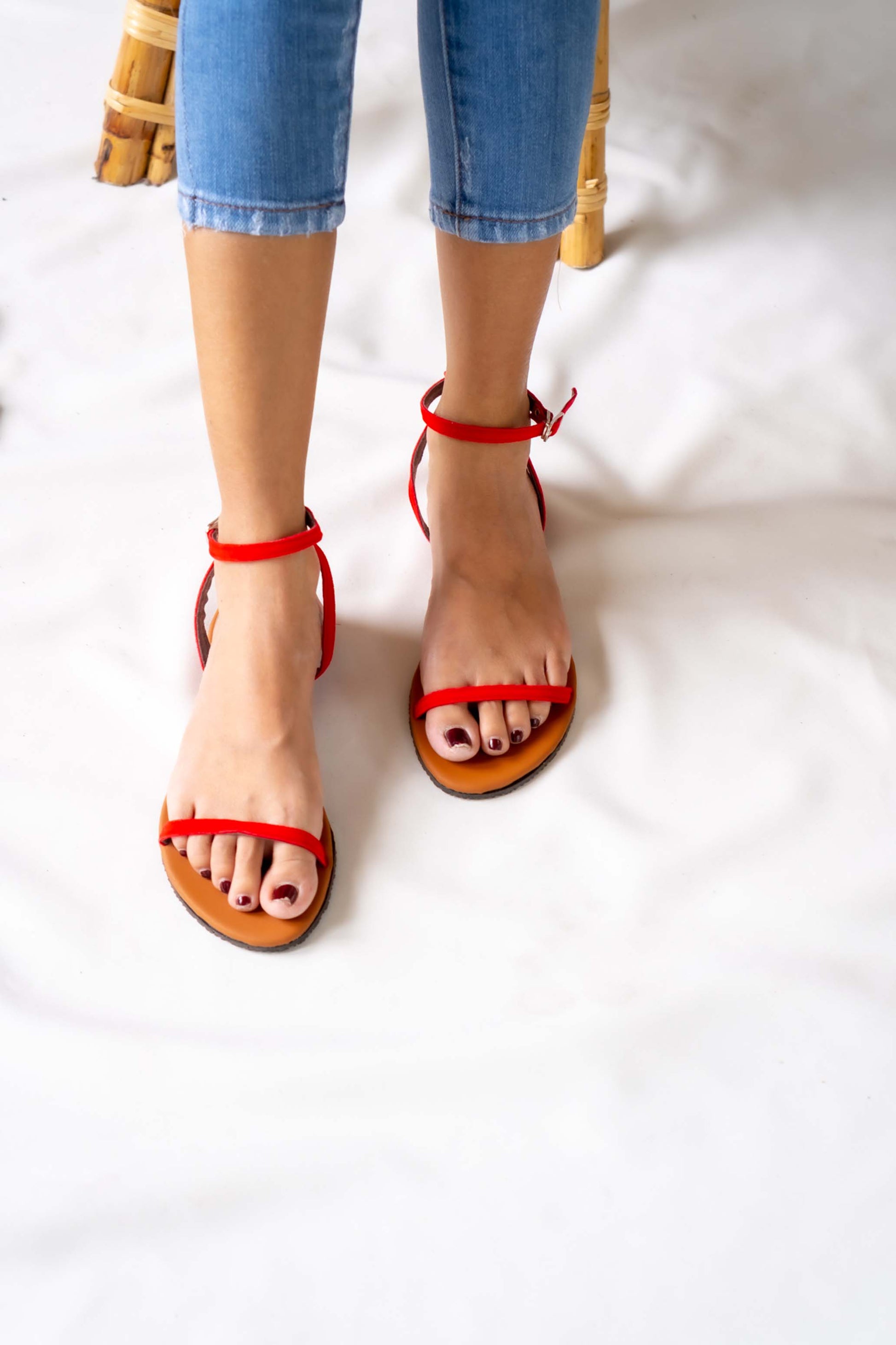 Sunny and stylish, this ladies' red flat sandal brings a pop of color to any outfit